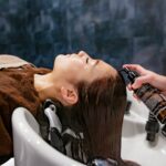 건강한 모발 가꾸기, 일상에서 실천하는 똑똑한 헤어 케어 트렌드 a woman getting her hair washed in a sink