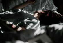 건강한 수면, 새로운 라이프스타일의 첫걸음 a person laying in a bed under a blanket