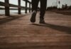 하루 한 번, 짧은 산책이 부르는 건강 혁신—“걷기 습관”이 만드는 변화 person in black pants and black shoes standing on brown wooden dock during daytime