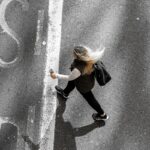 “작지만 소중한 쉼, 일상 속 정신건강 지키는 새로운 흐름” woman in black jacket and black pants walking on gray asphalt road during daytime