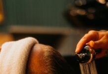 “건강한 모발 관리, 일상 속 작은 습관에서 시작하세요” a man getting his hair washed in a sink