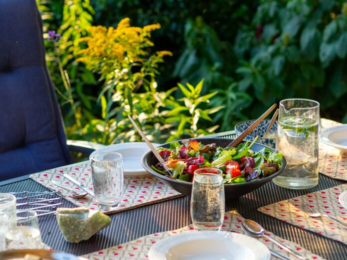 Photo by Jonathan Ybema a bowl of salad sitting on top of a table