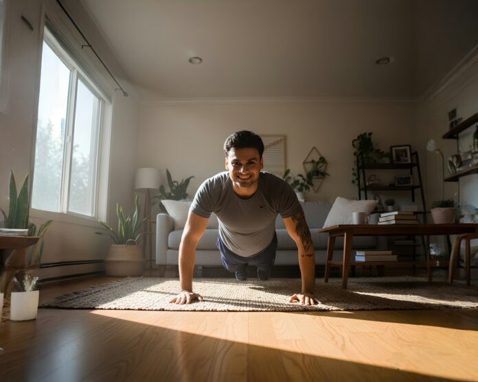 Photo by Rahul Gupta Man doing push-ups in a sunlit living room.
