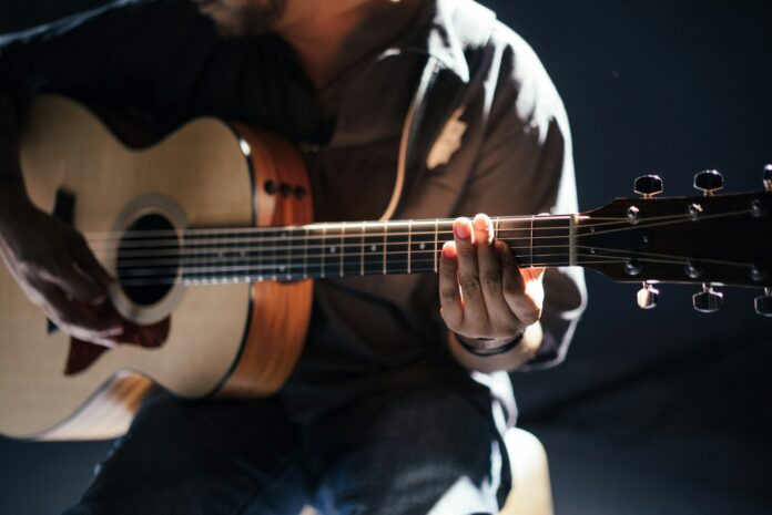 Photo by Gabriel Gurrola person playing guitar