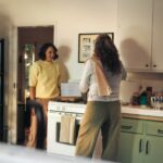 여성 건강관리, 생활 속 작은 변화에서 시작된다 Two women talking in a kitchen while cooking