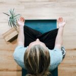 일상에 스며드는 대체요법, 건강 관리의 새로운 선택지 woman in black shirt and gray pants sitting on brown wooden bench