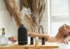 일상 속 대체요법, 작은 실천이 건강을 바꾼다 a woman laying in a bathtub next to a bottle of essential oils
