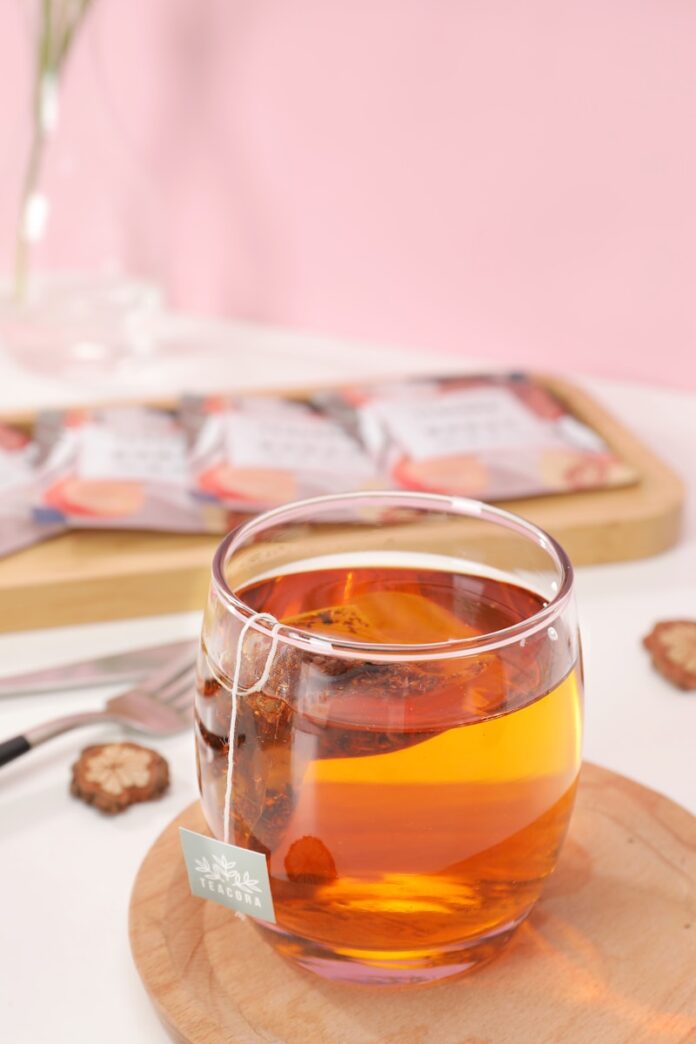 Photo by TeaCora Rooibos clear drinking glass with orange liquid