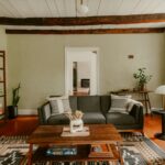 집에서도 실천하는 ‘마음을 돌보는 루틴’…한국인에게 맞는 자기돌봄 트렌드 확산 Living room with sofa, coffee table, and exposed beams