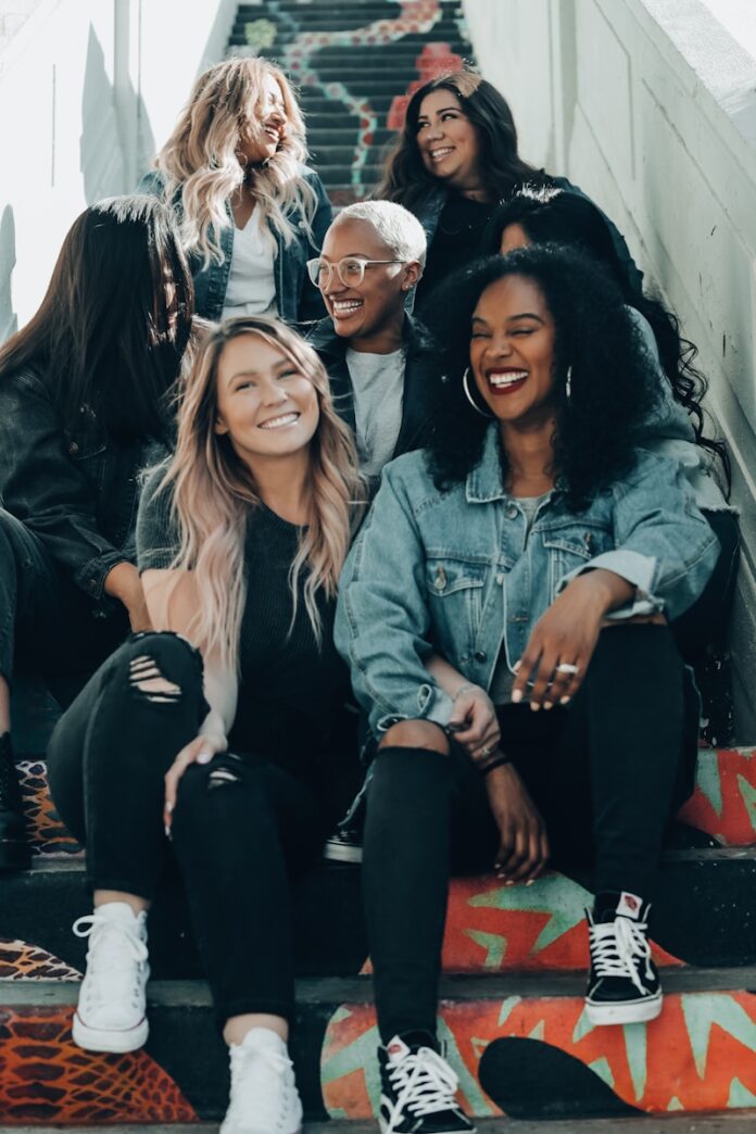 Photo by Joel Muniz group of women laughing on stairs