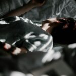 “숙면이 대세! 일상 속에서 쉽게 실천하는 건강한 수면 습관” a person laying in a bed under a blanket