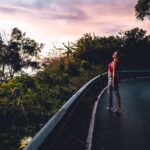 걷기로 시작하는 건강관리, 일상 속 실천법과 트렌드 woman in red tank top and blue denim jeans walking on gray concrete road during daytime