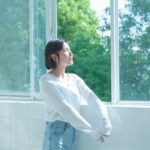 정신건강, ‘작은 습관’에서 시작한다… 일상에서 실천하는 마음 건강법 woman in white long sleeve shirt and blue denim jeans standing by the window