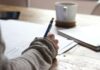 “끊이지 않는 피로감, ‘만성피로’ 극복하는 생활 속 작은 변화” person writing on brown wooden table near white ceramic mug