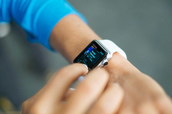 Photo by Luke Chesser person wearing silver Apple Watch with white Sport Band