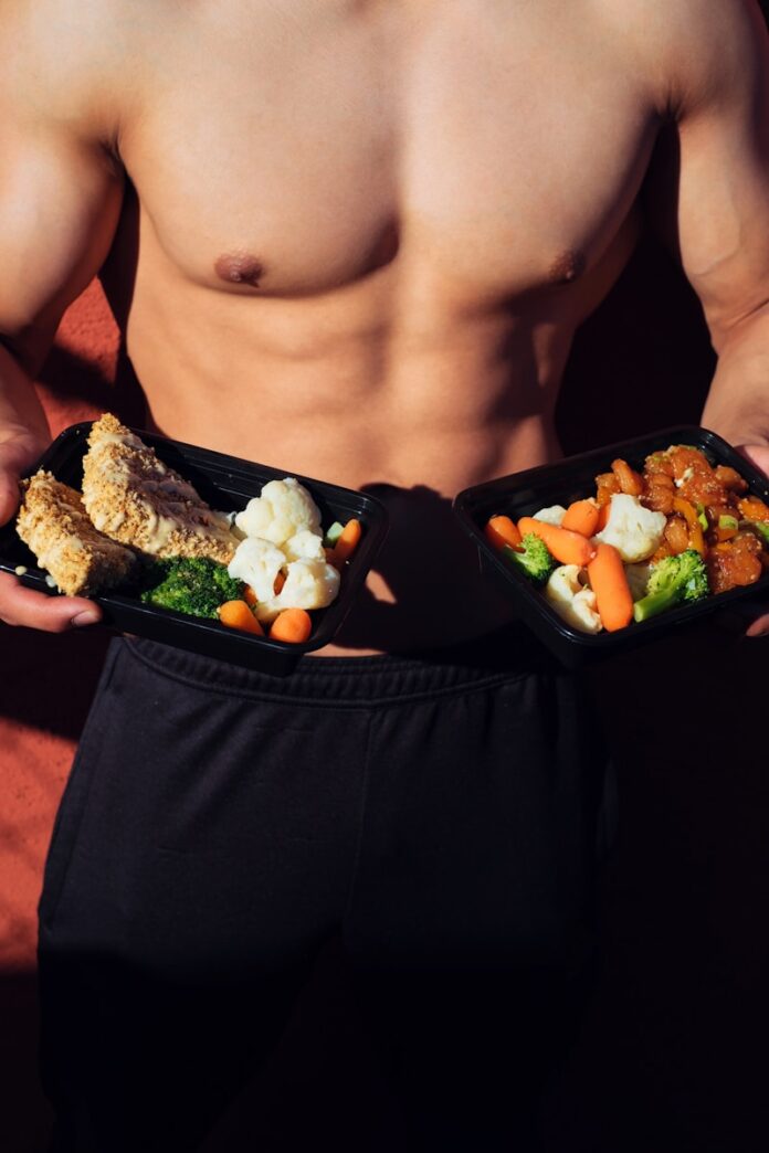 Photo by Mike Von topless man in black shorts holding cooked food