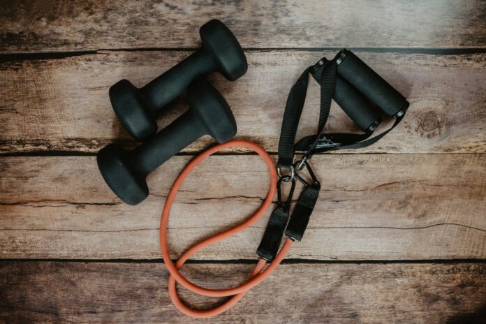Photo by Kelly Sikkema orange and black usb cable on brown wooden surface