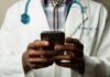 디지털 헬스케어, 손안의 건강관리 혁명 person wearing lavatory gown with green stethoscope on neck using phone while standing