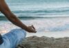 집에서 쉽게 실천하는 ‘마음챙김 명상’, 스트레스 줄이고 일상 활력 높인다 person in blue shorts sitting on beach shore during daytime