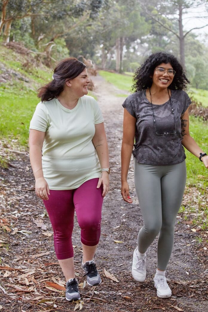 Photo by Sweet Life a couple of women walking down a dirt road