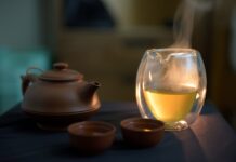수면 최적화로 당신의 하루를 살리세요: 건강한 잠을 위한 실전 팁 a glass of white wine next to a tea pot