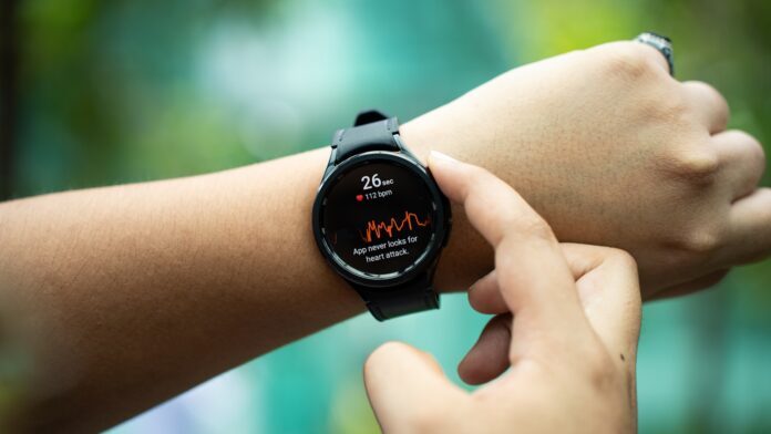 Photo by Amanz a close up of a person holding a smart watch