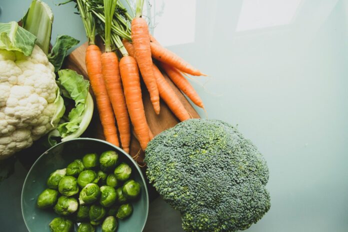 Photo by Louis Hansel carrots and broccoli on stainless steel bowl
