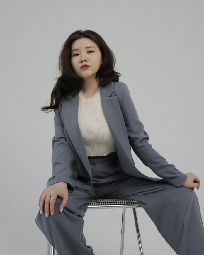 Photo by Shyngyskhan Tatubayev a woman sitting on top of a metal chair